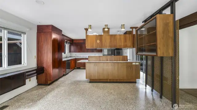 Suspended kitchen cabinets subtly separate the kitchen from the family room along with clever built-ins maximizing storage.