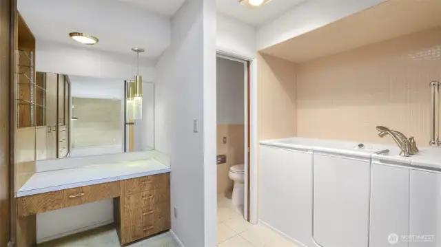 Open concept en-suite with built-in vanity, sit-down shower and private water closet.