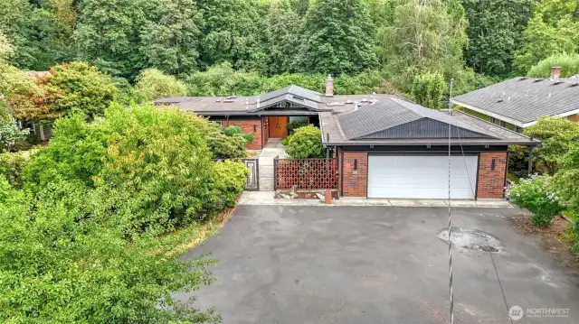 Home is surrounded by lush greenery from every corner of this property.