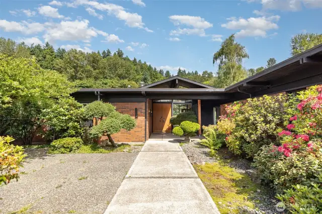 Home is surrounded by lush greenery from every corner of this property.