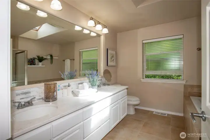 Primary Bath with Double Sinks, Stone Counters, Soaking Tub & Separate Shower & Tile Floors.