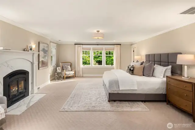 Right on our left up the stairs is this incredible primary.  Fireplace for cozy winter nights, and big bright windows.