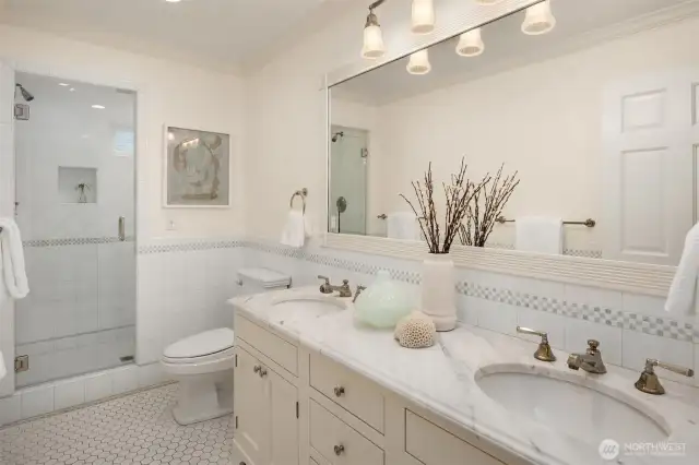 The third upstairs bathroom boasts double sinks and a beautifully tiled shower.