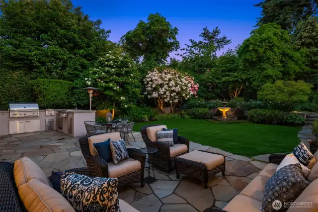 Patio right outside the main floor French doors holds ample space or entertainment - with a full outdoor kitchen and bar setup.