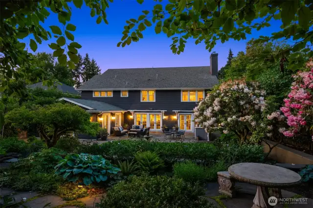 This yard is amazing!  Full of layers and surprises, there is a stone table and bench, fountain, and incredible landscaping.