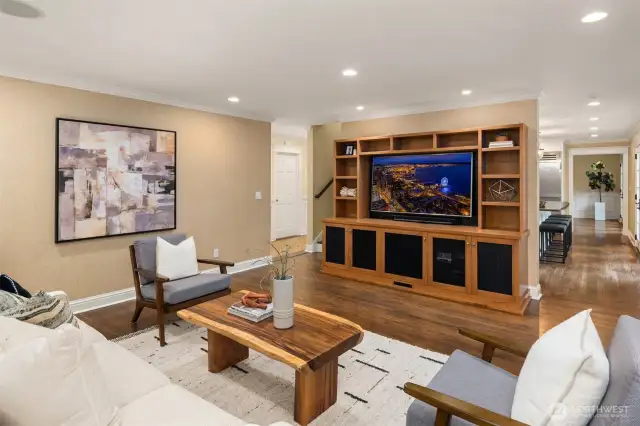 Kitchen flows right into the cozy family room.  Great space to gather and relax.  On the left of the built in is a back staircase leading right to the Primary Bedroom.
