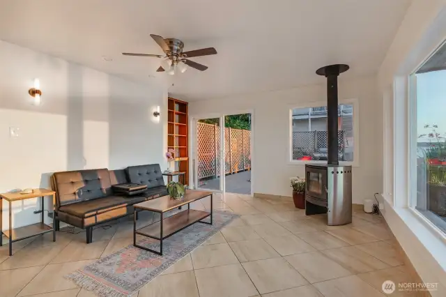 The living room offers a comfortable and cozy space to gather around the modern free-standing fireplace.