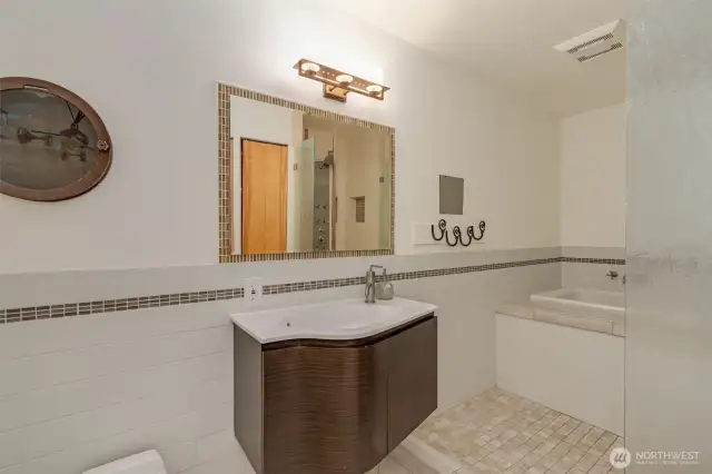 Spa like bathroom with custom tile and handsome fixtures.