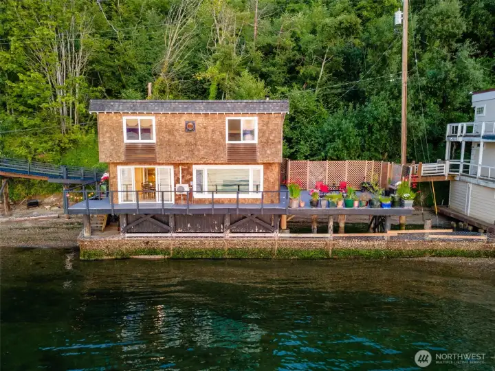 The home backs up to a lush green backdrop for a secluded feel.