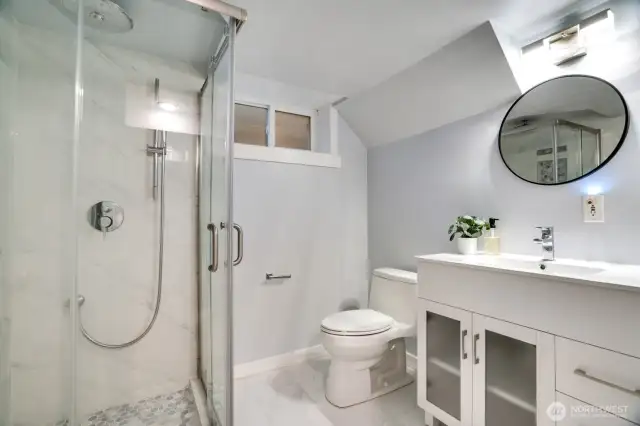 3/4 bathroom with mirrored thoughtful tile and flooring selections as upstairs bath.