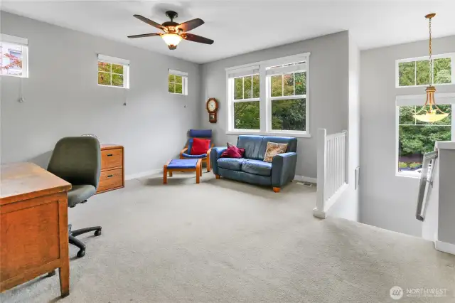 A cooling ceiling fan circulates air throughout the den/office and upper level.
