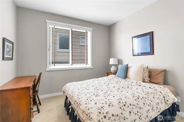 Bedroom two has a large window overlooking the side of the home and a second door leading into the full continental bath.