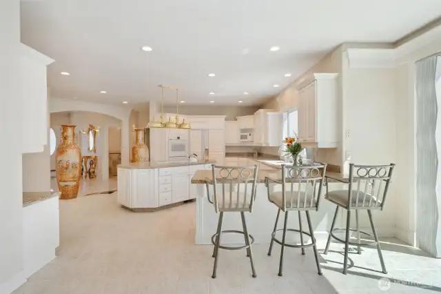 Kitchen with Bar Seating opens up to Patio