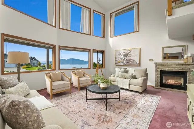 Great room has wall of windows showcasing view