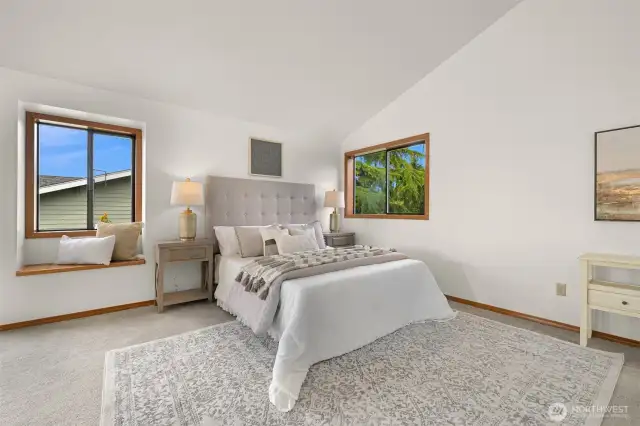 Oversized primary suite has vaulted ceilings