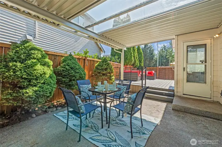 Covered back porch with skylight panels is the perfect spot for al fresco dining and entertaining.