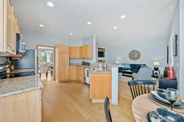 View from the corner of eat-in dining area with open sight lines to your rec room, kitchen, and formal living/dining area.