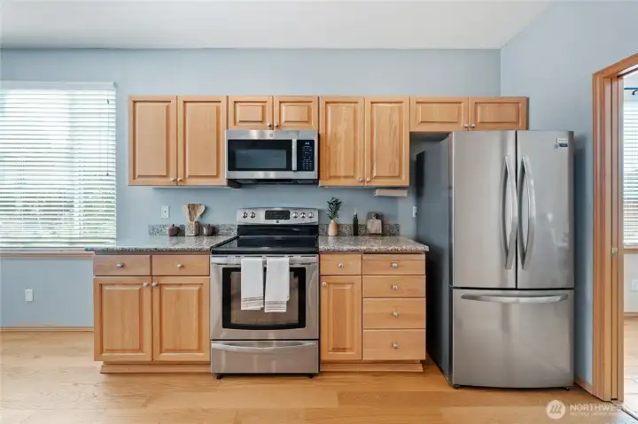 Stainless steel appliances, including the new refrigerator stay with the home.