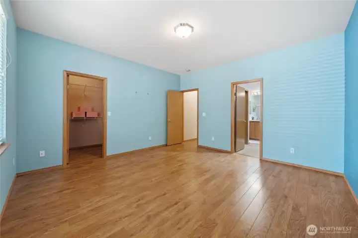 View from the corner of the primary bedroom of the walk-in closet and 5-piece bathroom.