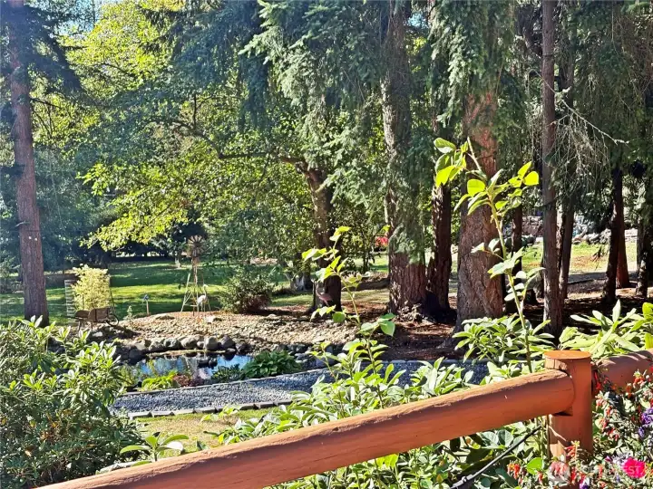 Charming pond seating area views from deck.  This pond area is wonderful to sit and enjoy a morning coffee in the sun, or an evening beverage in the shade.