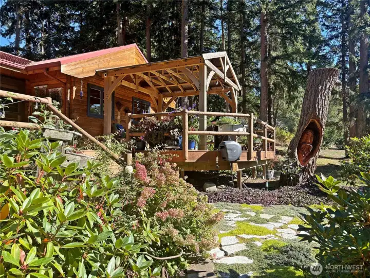 Here is the covered pavilion area - great area all year around!  Notice the wood carving in the tree stump beside the deck.