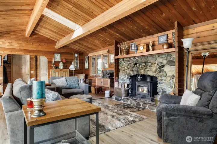 Cozy up to the wood stove!  Large windows and large skylights make the wood gleam.  New flooring too.  This Great Room has room for everyone, and has an expandable dining area suitable for large groups too.