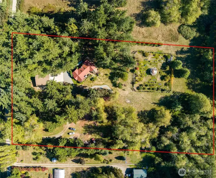 Welcome home!  You'll see the shop/garage building first, then the house.  Then, as you walk around, you'll discover the deer fenced gardens, complete with a glassed in garden gazebo in the center!  This is a really well conceived property with wonderful home & nature amenities to create a lifetime of memories.