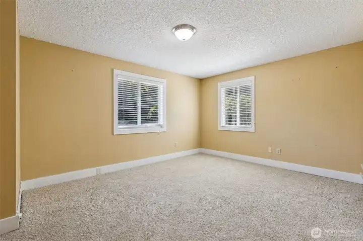 Bedroom #1 in Unit B is the perfect mix of spacious and inviting. The oatmeal carpeting and warm tone paint create a cozy, welcoming environment, while the huge picture windows let in plenty of light. With enough room for a home office or a sitting area, this space offers versatility for whatever you need. It’s the perfect place to unwind or get some work done.