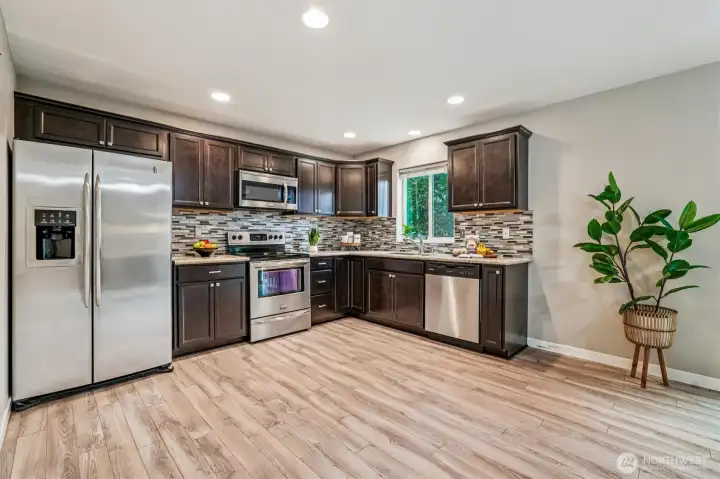 Spacous kitchen with stainless appliances & granite counters.