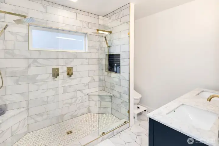 Luxurious ensuite with double vanity, double shower, and heated floors.