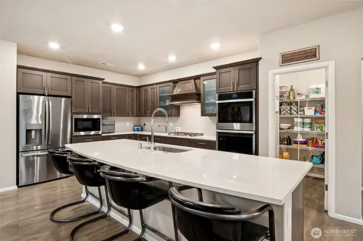 Kitchen with double ovens & a pantry that extends on and on