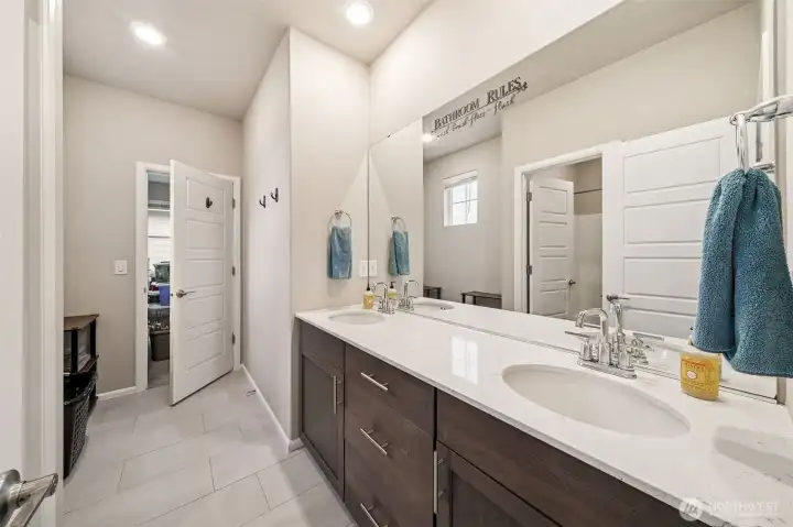 Main bath upstairs with door to bedroom 5