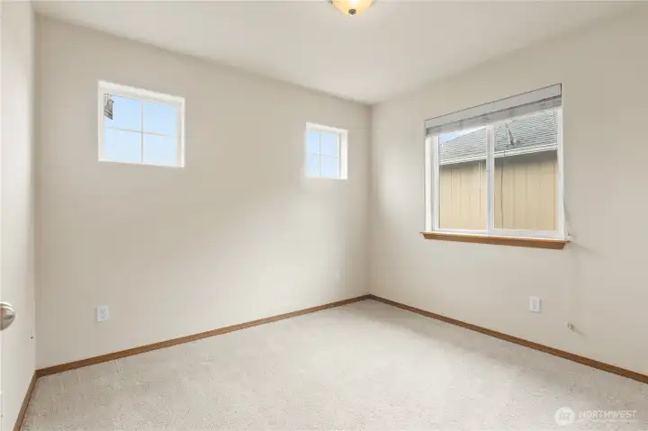 Pretty Guest bedroom 2 has many windows!
