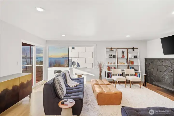 Formal living room with dramatic gas fireplace overlooking the sound. Ready to unwind at the end of the day