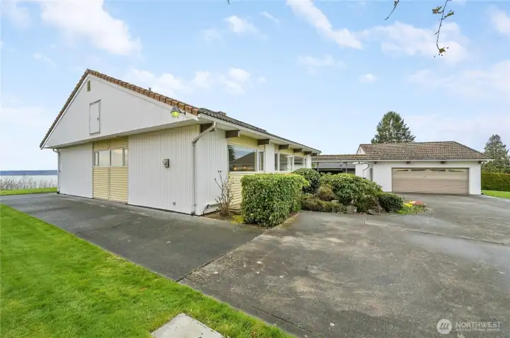 This beautifully maintained home sits on an expansive 17,000+ sq ft lot, offering exceptional space, privacy, and versatility. A generous driveway leads to a spacious 2-car garage and provides ample parking for a boat, RV, and all your recreational toys—plus plenty of room for guest parking. Framed by manicured landscaping and set against a serene water backdrop, the property blends everyday functionality with a peaceful, picturesque setting.