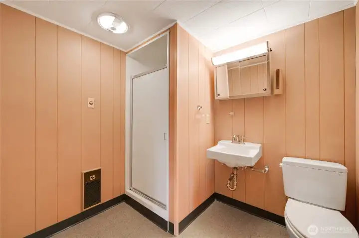 Convenient lower-level 1/2 bath with a functional layout—perfect for guests and easily accessible from the home’s entertainment spaces.