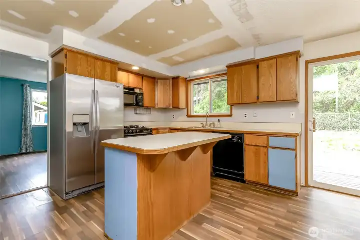Kitchen with center island.  Looking into bonus room.