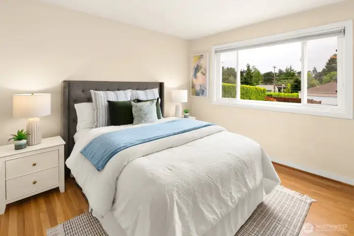 Primary bedroom on main floor overlooks the beautiful backyard.
