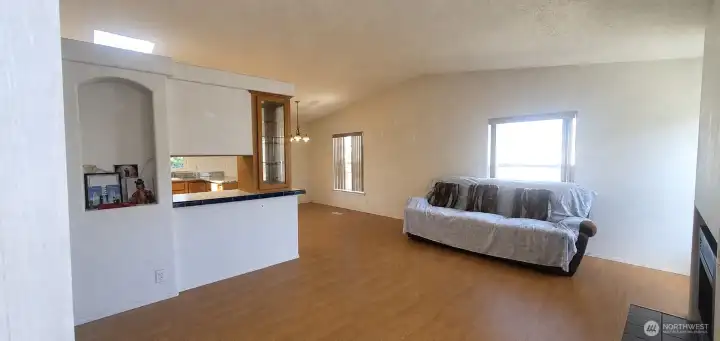 Bright living room with vaulted ceiling and gas fireplace
