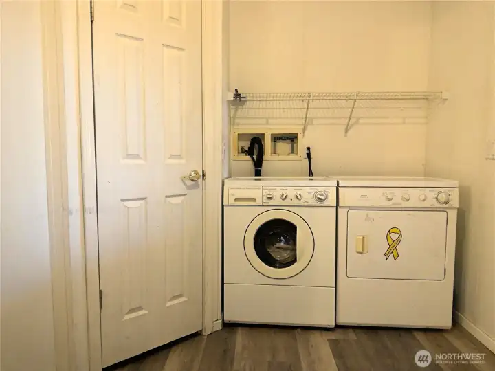 utility room has second pantry or linen closet