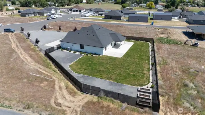 Backyard fully fenced with black chain link