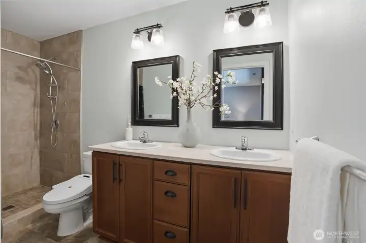 Primary bathroom with quartz counters, fully tiled shower and comfort height bidet toilet