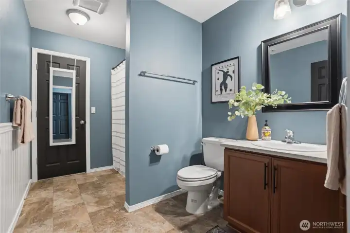 Guest Bathroom with full bath, shower and access to laundry room