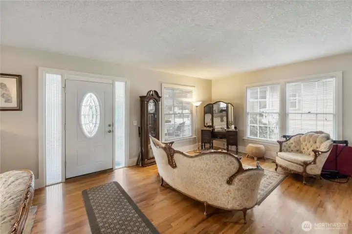 Entry into living room with original wood floors