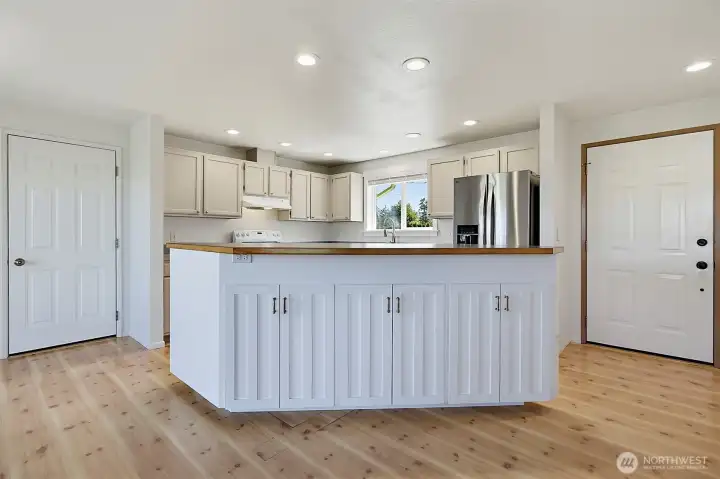 This serving island with power offers plenty of extra storage and doors on both sides for easy access.