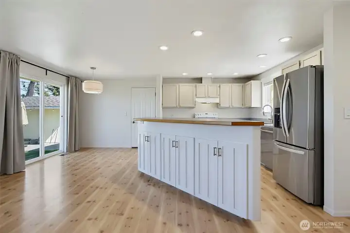 Great view of the kitchen serving island that overlooks the family room.