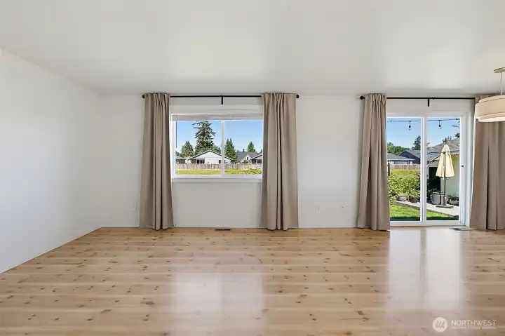 Bright large windows in the family room with sliding door to backyard patio.