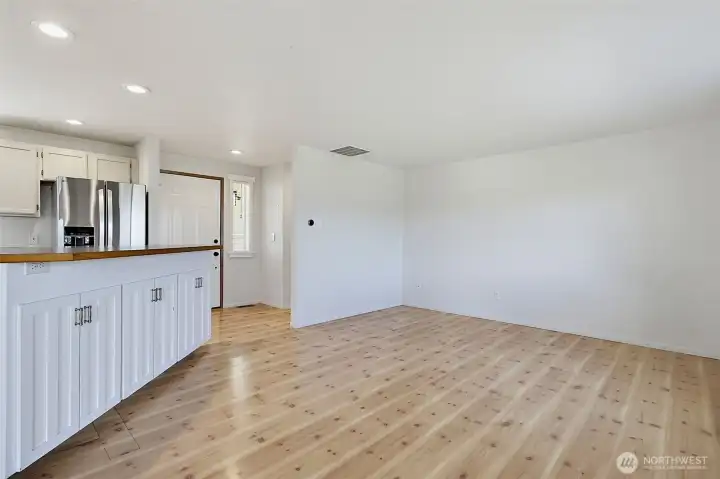 Open concept family room with hard surface flooring- views from the front door into the family room, kitchen & nook area.