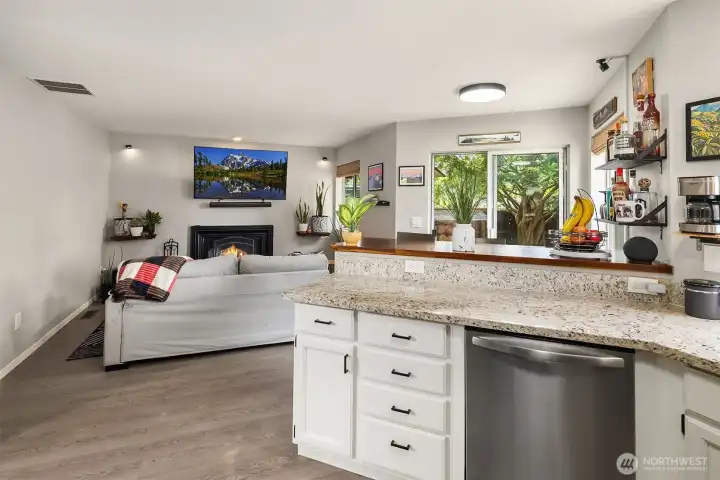 Kitchen with eating bar looking into family room