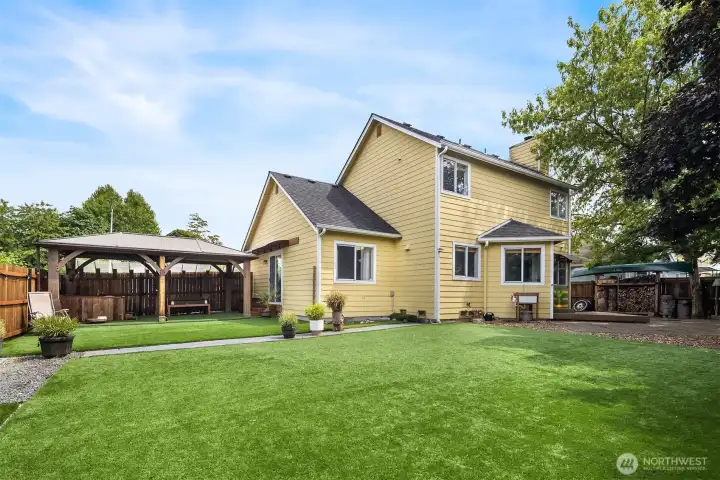 Backyard with artificial turf and north side yard with Gazebo and hot tub.